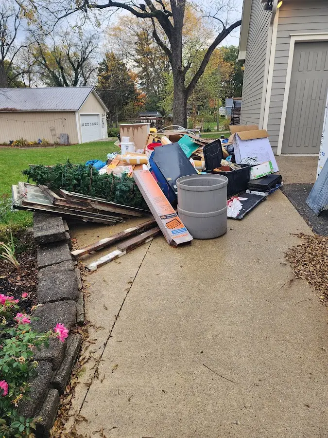 Dumpster being loaded with debris for Estate Cleanout Dumpster Rental in Corsicana